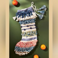 a stocking hanging on the wall next to oranges