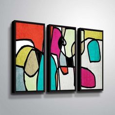 two abstract paintings hanging on the wall