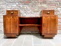 an old wooden desk with two drawers on it