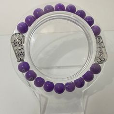 Purple with sliver bracelet Adjustable Purple Beaded Bracelet With Silver Beads, Elegant Purple Beaded Bracelets With Silver Beads, Elegant Silver Stretch Bracelet For Healing, Purple Beaded Bracelets With Large Beads, Purple Beaded Bracelets With Silver Beads For Jewelry Making, Purple Beaded Bracelet With Large Round Beads, Purple Round Bead Crystal Bracelet For Parties, Purple Beaded Bangle Bracelets For Party, Purple Bracelet With Silver Beads