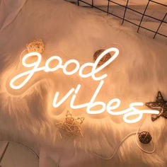 there is a neon sign that says good vibes