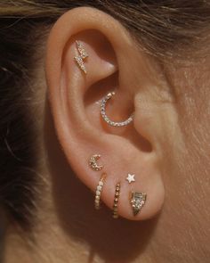 an ear with three different types of piercings on it