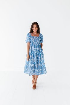 Features Square neckline Puff sleeves with elastic cuff Tiered skirt Ivory with blue floral print Pockets 60% Cotton, 40% Polyester; Lining: 100% Polyester Size + Fit Small 0-4, Medium 4-8, Large 8-12, 1X 12-16, 2X 16-20, 3X 20-24 Kristin is 5'4", a size 1 and is wearing a Small Jayce is 5'6", a size 18 and is wearing a 2X Runs true to size Measurements taken while laying flat and doubled. Bust measurements do not account for stretch. Click here for shoes shown in photos Size Bust Length Small 2 Blue Puff Sleeve Dress With Elastic Sleeves For Brunch, Blue Floral Print Midi Length Puff Sleeve Dress, Flowy Puff Sleeve Dress With Floral Print For Daywear, Blue Floral Print Midi Dress With Puff Sleeves, Blue Floral Print Puff Sleeve Dress, Blue Floral Print Puff Sleeve Midi Dress, Casual Puff Sleeve Dress With Balloon Sleeves For Spring, Casual Puff Sleeve Dress For Spring, Casual Floral Dress With Puff Sleeves