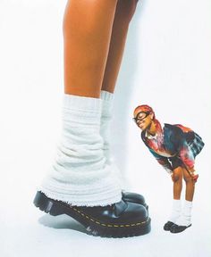 a woman's legs and shoes with the image of a doll on top of them