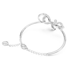 The most beautiful way to wrap your wrist, this bow-inspired bangle is one of the shining highlights of the Volta family. The bangle itself features a pavé of clear crystals, while the central ribbon design is elegantly adorned with more clear stones using the chattonage technique. Wear this rhodium plated piece of jewelry to create a look of modern elegance, or present it to someone as a gift on a special occasion. Article no.: 5647563 Collection: Volta Maximum length: 6 3/4 inches Motif length Evening Crystal Bracelet, Elegant Adjustable Bracelet With Bow, Elegant Adjustable Bracelet With Bow Detail, Elegant Adjustable Bracelets With Bow Detail, Adjustable Bow Jewelry For Evening, Bow Bracelet, Ribbon Design, Clear Stone, Clear Crystals