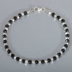 Silver Rondelle Bracelets With Silver Beads, Silver Rondelle Bracelets With Beads, Black Sterling Silver Bracelets With Silver Beads, Silver Bracelet With Round Black Beads, Silver Bracelets With Black Round Beads, Sterling Silver Crystal Bracelet With Round Beads, Black Beaded Sterling Silver Bracelets, Silver Crystal Bracelet With Black Beads, Silver Rondelle Bracelet With Spacer Beads