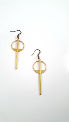 Simple and understated, these modern minimalist earrings are a great go to for everyday wear, to work or a night out. The earrings feature a long golden brass bar that is chin grazing through the middle of a brass geometric circle. These lightweight earrings hang about 2.75 inches in length while the circle hangs 1.5 inches length. The entire look is topped off with a nickel and lead free french ear wire. For more earrings check out our selection here: https://www.etsy.com/shop/DyNaModuo?section Simple Design Modern Gold Earrings, Modern Simple Design Gold Earrings, Modern Matte Gold Earrings, Matte Gold Minimalist Earrings, Modern Gold Earrings With Simple Design, Matte Gold Minimalist Metal Earrings, Minimalist Circle Brass Earrings, Geometric Metal Earrings For Everyday, Minimalist Metal Plug Earrings For Everyday