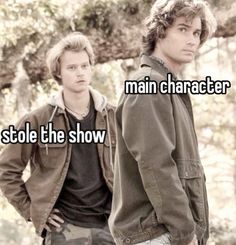 two young men standing next to each other with the words main character stole the show