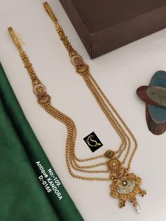 Description :- Gold Kamarpatta Waistbelt for Women - Elegant & Stylish Belly Chain for Weddings, Other Occasions - Stunning Piece for Occasion Gift yourself a royal look with this perfectly crafted necklace set from Manalisstudio. Crafted with high quality stones, it is impressive in design. The green enamel artwork adds perfect texture to the design. Perfect for weddings and festivities, this antique necklace set should be put on with your favorite sari or lehenga. 100% Satisfaction. Long Lasti Gold Kundan Mala For Rituals, Gold Mala With Cutdana For Rituals, Gold Kundan Mala With Latkans, Gold Mala With Latkans For Rituals, Necklace On Saree, Chabi Challa, Saree Pin, Box Making, Belly Chain