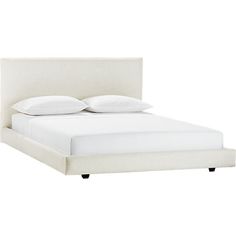 a bed with white linens and pillows on it's headboard, against a white background