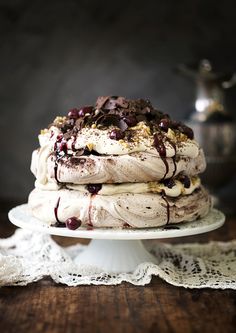 a cake on a plate with chocolate and cream toppings