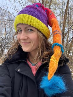 Stay warm with a touch of whimsy in this colorful sleeper hat.  Handmade with color changing yarn and without a pattern, each hat is created as a work of art making it a one-of-a-kind. Multicolor Beanie Mini Hat For Winter, Fun Brimmed Mini Hats For Winter, Multicolor Mini Beanie Hats For Winter, Fun Multicolor Costume Hats And Headpieces, Fun Winter Hat One Size, Fun One-size Winter Hat, Winter Festival Beanie Mini Hat, Multicolor Yarn Mini Hat One Size, Whimsical Beanie For Winter