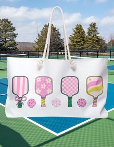 This is the perfect bag to take to the court or a weekend trip!  Our oversized Weekender Tote is perfect for your weekend at the beach or in town. The wide-mouthed, durable bag holds a generous amount of personal items and is easily held by its thick rope handles. .: One size: 24" x13" (60.9 cm x 33 cm) .: 100% Spun Polyester .: T-bottom .: Cream sheeting interior lining .: NB! Size tolerance 0.75" (1.9 cm)) .: Assembled in the USA from globally sourced parts White Tote Bag For Outdoor Activities, White Tote Bags For Sports Events, White Tote Bag For Sports Events, White Sports Tote Bag, Pickle Ball Bag Pattern, Pickleball Bags For Women, Pickleball Bag, Sporty T-shirt For Summer Pickleball, Sports Season T-shirt With Team Name For Pickleball