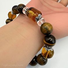 Enhance your prosperity and attract positive energy with this exquisite Feng Shui "God of Wealth" Tiger Eye Stone Beads Bracelet. Available in both 10mm and 12mm bead sizes, this bracelet is designed to bring balance, protection, and abundance to its wearer. Perfect for both men and women, it serves as a powerful Feng Shui enhancer that aligns with your personal goals of wealth and success. Features: Premium Tiger Eye Stones: Renowned in Feng Shui for their protective qualities, these natural Ti Attract Positive Energy, God Of Wealth, Bead Sizes, Tiger Eye Bracelet, Layered Fashion, Tiger Eye Stone, Eye Stone, Personal Goals, Beads Bracelet