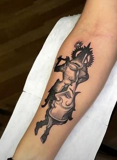 a woman's arm with a tattoo on it that has an image of a man riding a horse