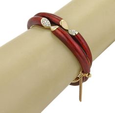 "This is an eye catching red enamel bracelet, it is crafted from solid 18k yellow gold with a double band style adorned with dark red guilloche enamel, the front center has a slanted cut out ends barely touching one end with diamond and the other with white enamel. This fine piece is hinged halfway across and the back is also in a double band style which is smaller then the stylish front, it fastens with a push in clasp and chain attached for added security. Material: 18k yellow gold. Measuremen Elegant Red Enamel Bracelets, Guilloche Enamel, Enamel Bracelet, Band Bracelet, White Enamel, Dark Red, Leather Bracelet, Cut Out, Bangles