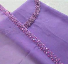 a purple dress with beading on it