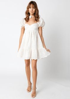 Nothing says chic and elegant like the Tate Cream Eyelet Puff Sleeve Mini Dress! Cream eyelet lace fabric forms a puff sleeve babydoll dress with a sweetheart neckline and a tiered, scalloped hem. Features ties at the sleeves. Lined. DETAILS & FIT Short Babydoll Bodice. 80% Tencel, 20% Polyester. Lining: Cotton Machine wash cold. Imported. SHIPPING & RETURNS Orders are processed within 1-2 business days. Packages are shipped out Monday-Friday, holidays are excluded. Priority, Priority Mail Expre Puff Sleeve Dress With Sweetheart Neckline For Garden Party, Garden Party Puff Sleeve Dress With Sweetheart Neckline, Feminine Puff Sleeve Dress With Ruffles And Sweetheart Neckline, Feminine Puff Sleeve Dress With Sweetheart Neckline And Ruffles, Puff Sleeve Mini Dress With Lace Trim, Spring Puff Sleeve Dress With Ruffles And Sweetheart Neckline, Feminine Puff Sleeve Dress With Sweetheart Neckline For Brunch, Feminine Puff Sleeve Dress With Lace Trim, Feminine Fitted Puff Sleeve Dress With Lace Trim