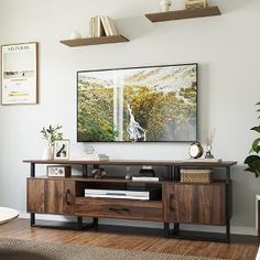 a living room with white walls and wooden furniture in front of a painting on the wall