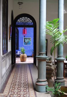 an entrance way with columns and potted plants