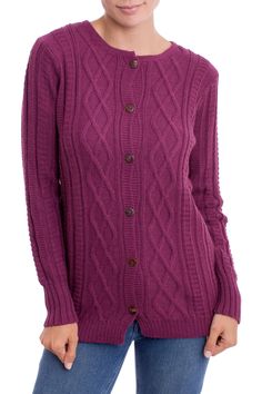 a woman wearing a purple cable knit cardigan sweater with buttons on the front and side