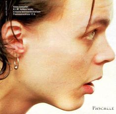 a close up of a person's face with ear piercings on their ears