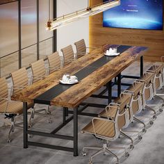 a long table with chairs and plates on it in front of a flat screen tv