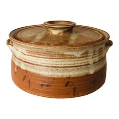 a brown and white ceramic pot with lid