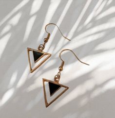 Handmade gold and black triangle dangle drop earrings Size - 2cm x 1.7 Closure - push back Gold Triangle Metal Earrings, Triangle Gold Metal Earrings, Trendy Gold Triangle Earrings, Minimalist Nickel-free Triangle Earrings, Nickel Free Triangle Metal Earrings, Nickel-free Metal Triangle Earrings, Trendy Triangle Earrings, Trendy Black Nickel-free Earrings, Black Minimalist Pierced Earrings