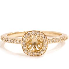 a gold ring with an oval shaped diamond in the center and two rows of diamonds around it