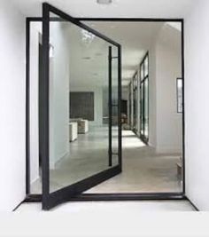 an empty hallway with glass doors leading to another room