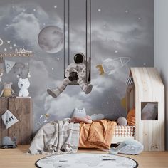 a child's bedroom decorated in grey and white with an astronaut themed wall mural