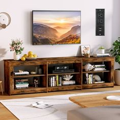 a living room with a large television mounted on the wall