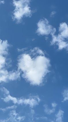 the plane is flying high in the blue sky with white clouds above it and an airplane that has just taken off