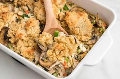 a casserole dish filled with stuffing and vegetables