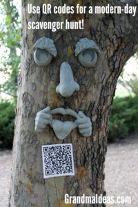 a tree with a face on it and a qr code attached to the trunk