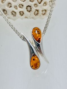 Elegant ,stylish sterling silver pendant ,decorated with genuine Baltic amber of classic-Honey color.Classic style this pendant ready to be worn different occasions. Material : genuine Baltic amber with sterling silver Color  :  Classic Honey Dimensions  :  27 x 12 mm Finish  :  Polished Chain not included. All our product handcrafted ,manually processing, by professional jewelry-artists. Luxury Elegant Amber Crystal Necklaces, Elegant Amber Sterling Silver Necklace, Formal Orange Sterling Silver Necklace, Amber Necklace With Polished Finish For Anniversary, Elegant Baltic Amber Necklace In Orange, Elegant Orange Necklace With Polished Finish, Elegant Orange Baltic Amber Necklace, Sterling Silver Amber Teardrop Pendant Necklace, Elegant Amber Teardrop Pendant Necklaces