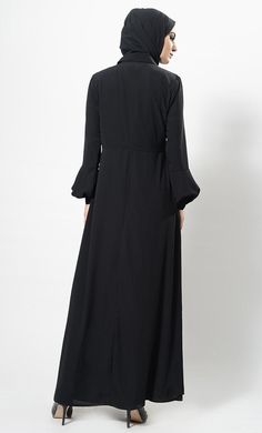 Featuring a casual everyday shirt style abaya dress in nida base with hidden overlapping button closure placket at the centre front. Its a simple muslimah abaya with bishop style sleeves and A line silhouette perfect to be worn daily for informal ocassions.FIT : Relaxed fit.COMPOSITION : Nida.CARE : Dry clean only. Maxi Length Abaya For Fall Workwear, Fall Workwear Abaya In Maxi Length, Fall Workwear Maxi Length Abaya, Modest Maxi Length Abaya For Fall, Fall Modest Maxi Length Abaya, Fall Season Modest Maxi Length Abaya, Modest Solid Color Maxi Dress, Long Sleeve Abaya For Work, Solid Long Sleeve Abaya For Work