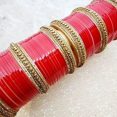 Embrace the captivating charm of wearing this traditional choora, specially crafted for brides seeking a touch of individuality. Beyond the wedding day, these gold studded karra bangles can be cherished and worn again. Made to be worn on both arms, this set promises to become a cherished accessory that is uniquely you. You'll elevate your bridal look with our ethereal gold-pearl embellished bangles zircon stone studded accents and striking red choora bangles. *please note Banglez Choora are fina Adjustable Wedding Jewelry With Zari Work, Adjustable Zari Work Jewelry For Wedding, Adjustable Zari Work Wedding Jewelry, Red Tilla Jewelry For Marriage, Festive Kundan Bracelets For Marriage, Kundan Bracelets For Marriage And Festivals, Traditional Kundan Bracelets For Marriage, Traditional Hand Set Bracelets For Marriage, Red Tilla Bridal Sets For Marriage