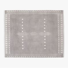 a gray rug with white dots and lines on the side, in front of a white background