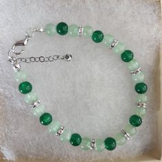 Green Round Bead Bracelet ,Rhinestone Spacers,Glass Bead Bracelet, Green Color,  Green Glass Bead Bracelet, Rhinestones, Silver Lobster Clasp Approximately 7 inches, make sure this will fit your wrist. Beads used are 6 mm in diameter  Rhinestone Spacers All my bracelets are handmade. Please note -  I do my very best to give you accurate measurements and descriptions All my jewelry is delivered in a gift box and beautiful organza gift bag, perfect for keeping your jewelry safe, or ready to give if it is a gift! No refunds or exchanges * see more brackets at https://decowrist.etsy.com/ Cheap Green Pearl Bracelet With Round Beads, Cheap Green Bracelets For Holiday, Silver Jade Beaded Bracelets As Gift, Green Beaded Bracelets With Stones As Gift, Green Beaded Stone Bracelets As Gift, Silver Crystal Bracelets With 8mm Beads, Silver Crystal Bracelets With Beads, Jade Jewelry With Round Beads And Stones, Elegant Green Beaded Charm Bracelet