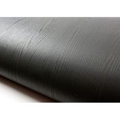 a roll of black fabric on top of a white table