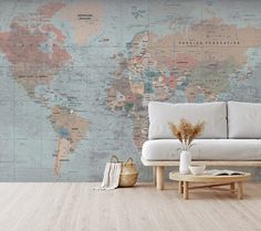 a living room with a couch, coffee table and large world map on the wall