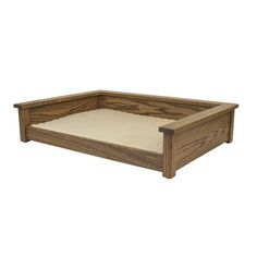 the dog bed is made from wood and has a white mattress on top of it