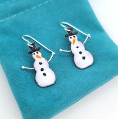 These little snowmen earrings are a fun new addition to my line of enamel jewelry and holiday earrings. They will be a happy pair to wear through Christmas and the winter months :) The earrings are created from glass enamel fused to copper, with sterling silver arms and sterling silver ear wires at the top. Fun Enamel Earrings For Gifts, Snowmen Earrings, Snowman Earrings, Holiday Earrings, Holiday Earring, Savannah Ga, Christmas Earrings, Enamel Jewelry, Winter Months