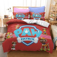 a bed with paw patrol comforter and pillows