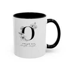 a black and white coffee mug with the letter o on it's front side