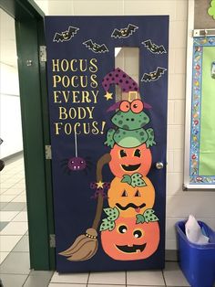 a door decorated with pumpkins and witches for the halloween classroom decorating contest at st mary's catholic church