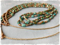 Native American multi strand heishi necklace with turquoise and shell by artist Jeanette Calabaza 26" Beautiful necklace with soft greenish tone of turquoise beads and light brown shell beads. Smooth finish for comfortable wear, 3 strands and tie closure. By the talented Santo Domingo artist Jeanette Calabaza. Measurements: 26" long (beaded part) cord 8" (each side) 3mm shell beads 5mm turquoise beads Adjustable Artisan Turquoise Heishi Beads Necklace, Adjustable Artisan Turquoise Necklace With Heishi Beads, Adjustable Multi-strand Artisan Turquoise Necklace, Green Double Strand Bohemian Turquoise Necklace, Green Turquoise Double Strand Bohemian Necklace, Green Bohemian Double Strand Turquoise Necklace, Adjustable Bohemian Turquoise Necklace With Heishi Beads, Hand-strung Multi-strand Bohemian Turquoise Necklace, Bohemian Multi-strand Hand-strung Turquoise Necklace