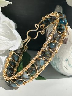 This boho bangle bracelet is inspired by the pure and natural beauty of the beach.  In fact, many of the products in my shop are handmade on the beach while savoring the cool breeze and calming ocean sounds. The gemstone, light blue imperial jasper, boasts a light blue and brown swirl pattern and is absolutely beautiful  This gemstone looks amazing with a pair of jeans or dressed up with a beautiful dress  Imperial Jasper is a nurturing gemstone that stimulates peace, serenity, and relaxation. I Crystal Ideas, Boho Bangle Bracelets, Gemstone Bangle Bracelets, Male Jewelry, Wire Jewelery, Boho Bangle, Blue Beaded Bracelets, Arm Jewelry, Gemstone Bangle